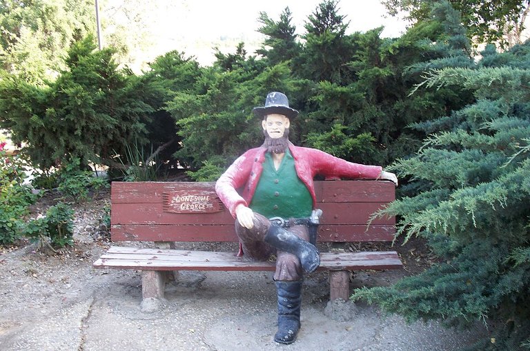 Statue of an old man on a bench built by an aged visionary named John Ehn, a classic victim of dementia concretia.